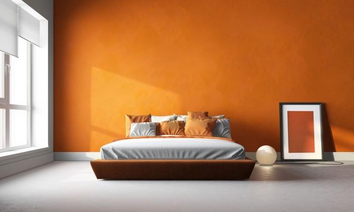 modern sovrumsfärgidé i orange, mandarinfärg för sovrum, stor sängmodell i brun ram