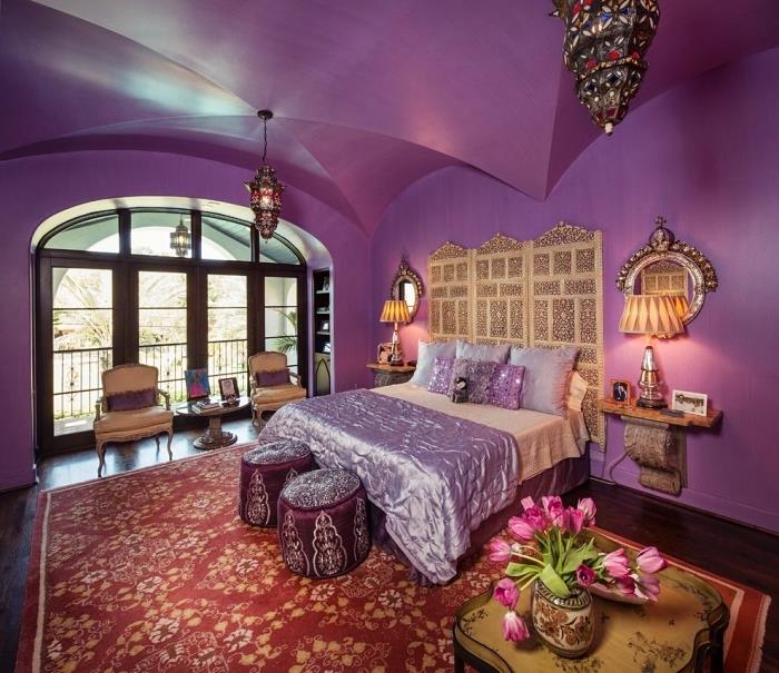 príklad dekorácie orientálneho čela v priestrannej spálni s purpurovými stenami zariadenej etnickým nábytkom a doplnkami