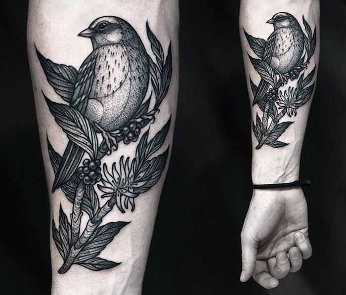 fågeltatuering original i svart på armen, modell tatuering design av fågel uppflugen på en blommande gren