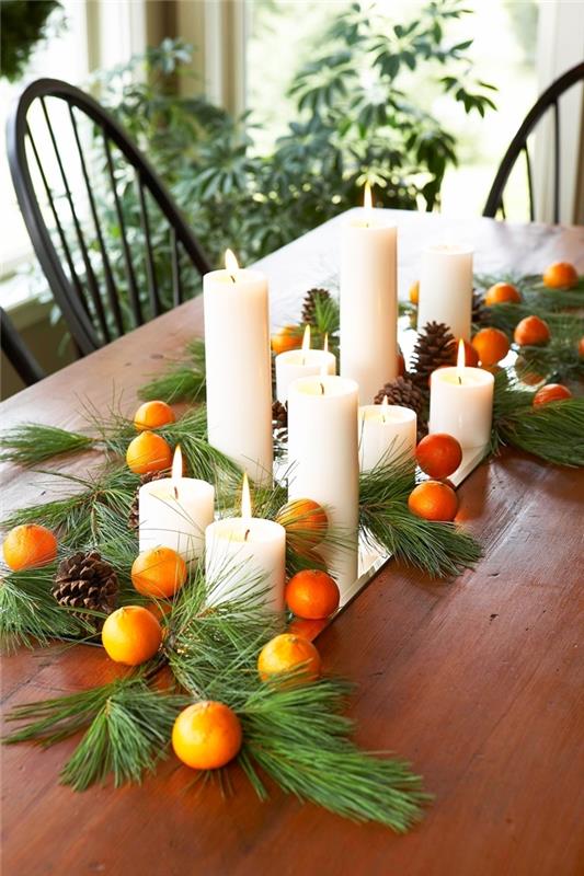 apelsiner tallkottar mittpunkt jul DIY vita ljus gröna julgransgrenar