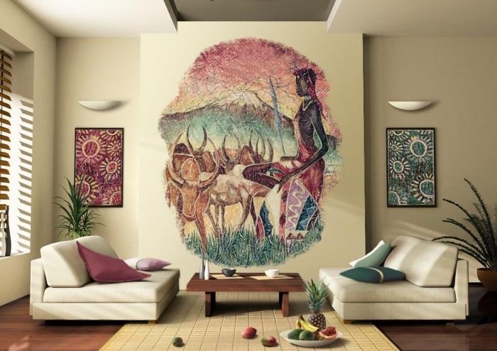 Africký duch v béžovej obývacej izbe zariadenej nízkymi pohovkami a konferenčným stolíkom z tmavého dreva, nástennou dekoráciou s africkou krajinomaľbou