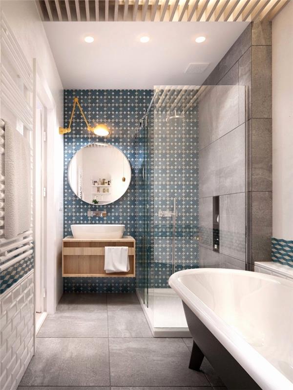 moderná kúpeľňa v šedej farbe s jemne vzorovanou kameninovou cementovou dlažbou v modrozelenej modrej, ktorá definuje priestor za umývadlom