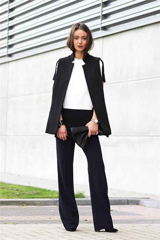 elegant silhuett med rena linjer med kvinnokläder i svart ärmlös kavaj och flytande byxor