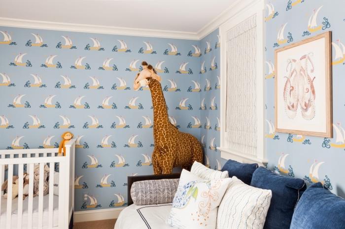 model dekorácie spálne pre chlapca so svetlomodrou tapetou v námorníckom štýle a veľkou plyšovou hračkou v tvare žirafy