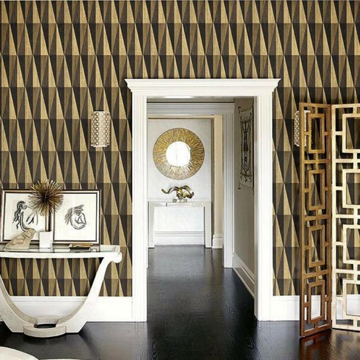 geometrisk tapet trompe l'oeil tapet, ingång i arty -stil, vit dörrkarm, vitmålat entrébord i trä, bronsfärgad metallvägglampa med genombruten effekt
