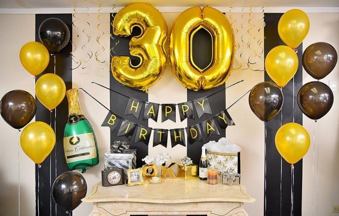 svart och guld födelsedagsdekoration för en fest hemma, festhörna med heliumballonger och ballong i gyllene nummer