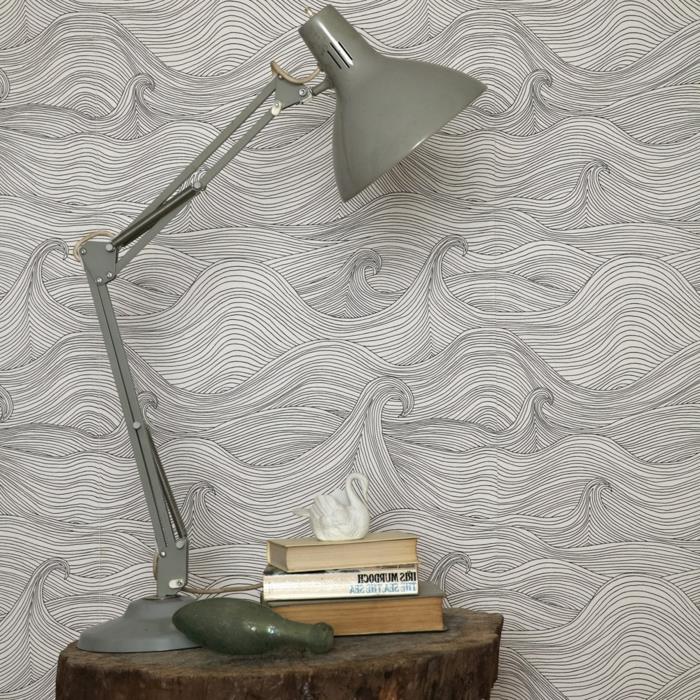 trompe l'oeil tapet med grå vågmönster, grovt hav, sängskåp i form av en trädstam, golvlampa av grå metall i säng, 3 böcker i fickformat på sängbordet, liten vit svan som dekorationsföremål