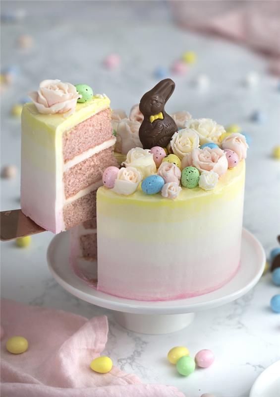 Påsktema lagerkaka recept på rosa sockerkaka fylld med smörkräm, med ganska gradientglasyr dekorerad med små marsipanrosor och chokladägg, enkel och förfinad påskmeny