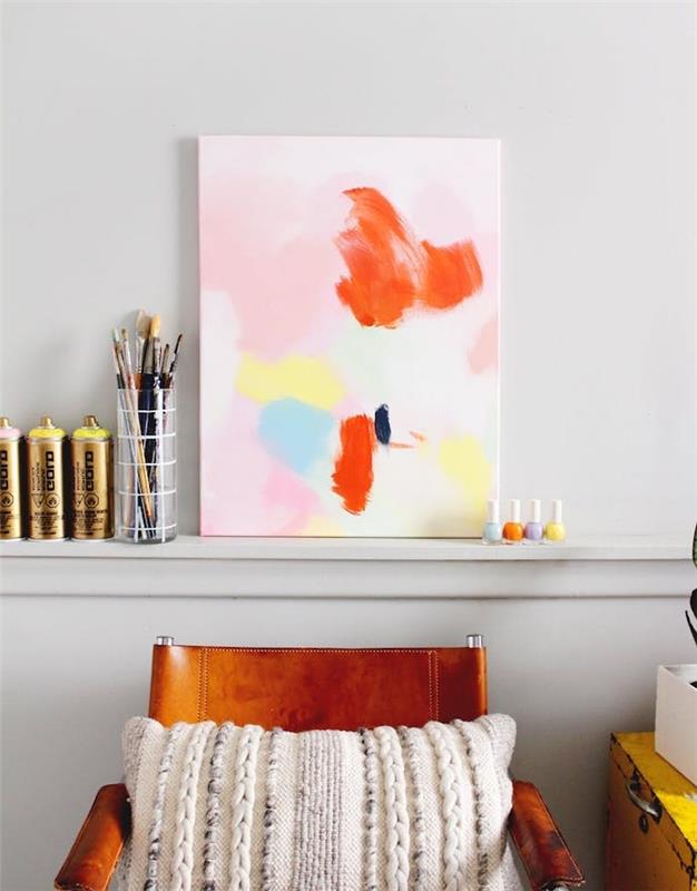 DIY tonårssovrum, en abstrakt målning på vit duk, färgglada färgfläckar, trä- och läderstol, konstnärlig atmosfär