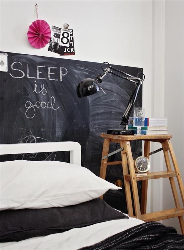 skifferväggsfärg som designerhuvud, sängkläder i svart och vitt, sängbord i trappsteg