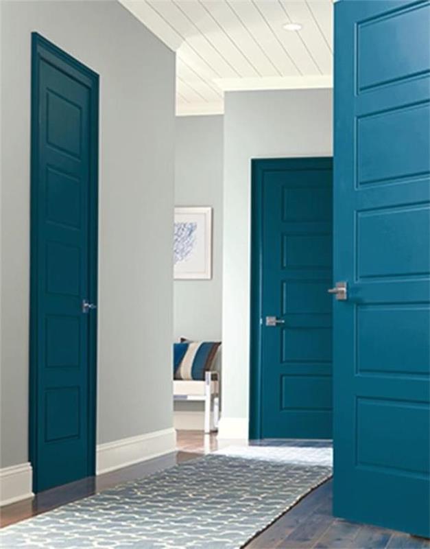 måla hall och dörrar målade i blå vid på väggar i neutral färg en soffa längst bak i rummet vilken färg man ska måla dörrarna till en hall