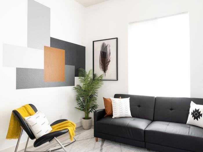 geometrický obraz obývačka moderná výzdoba rozloženie obývačky čierna gombíková pohovka biely vankúš čierna stolička žltý hod