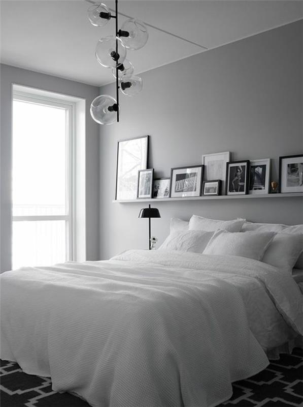 pärlgrått sovrum med en svart metallarmatur och stora klorglas