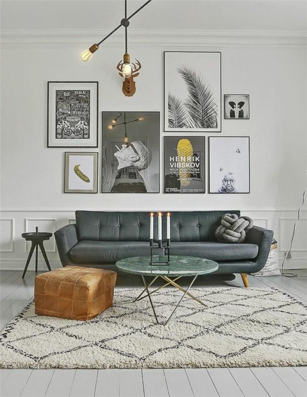 perleťovo šedá umelecká obývacia izba s umeleckými predmetmi, štvorcový puf, zelený okrúhly stôl s kovovými nohami a kobercom v bielej a čiernej farbe