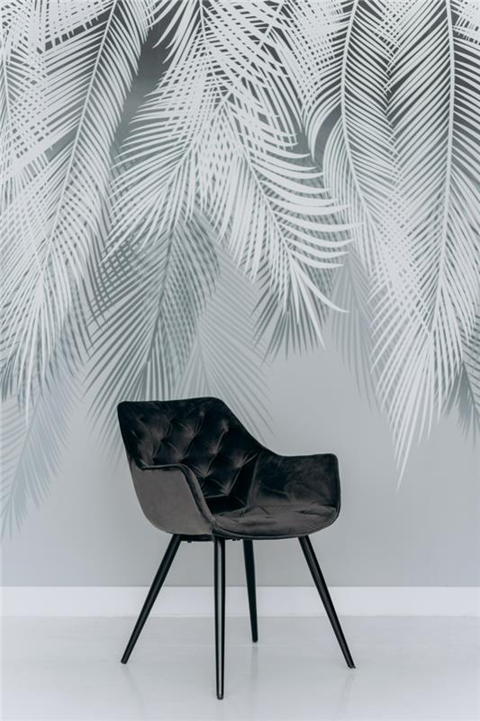 grå färg svart stol framför en grå vägg