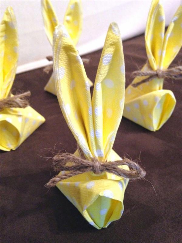 pappersservett i form av en påskhare knuten med en hampsträng, små kaniner i gult papper med vita prickar