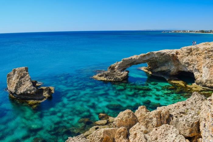 azurblått hav med lerstenar, horisont i blått och grönt, landskapstapeter, himmel i pastellblå, gröna och blå nyanser av vattnet