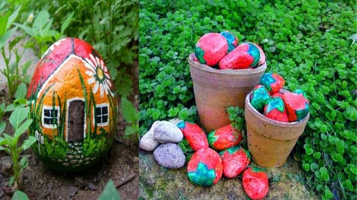 blomkrukor fyllda med småsten målade som jordgubbar, husritade stenar placerade i trädgårdsbädden