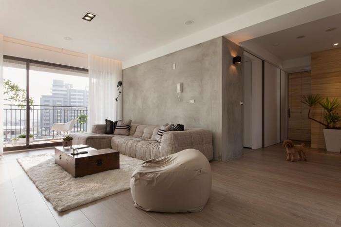 rozloženie obývačky s dreveným nábytkom, výzdoba miestnosti so stenami z voskovaného betónu, podlahy z imitácie dreva