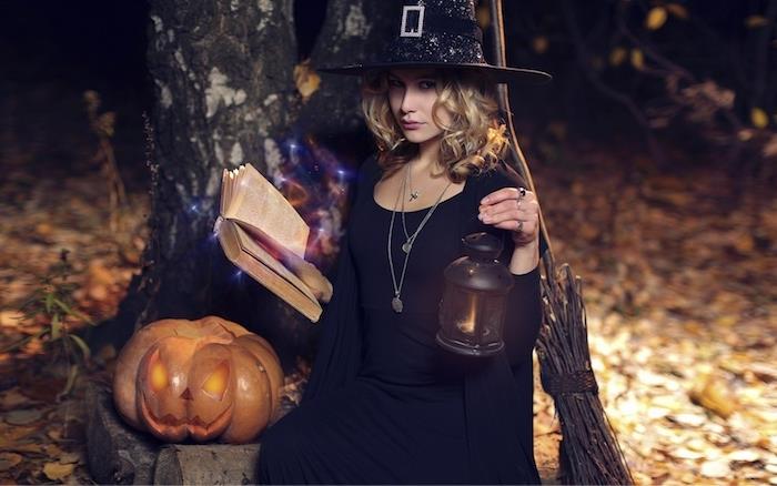 svart hatt häxkostym, svart klänning och väst, häxetillbehör, grimoire magisk bok, svart lykta, snidad pumpa jack o lykta