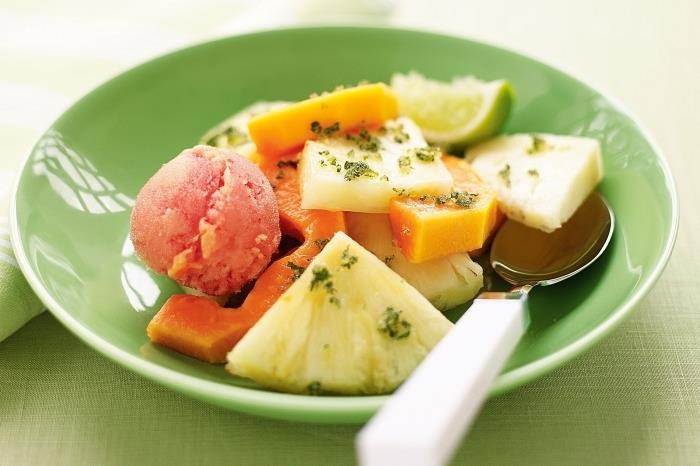 jednoduchý a osviežujúci recept na ovocný šalát z papáje a ananásu, s citrónovou šťavou a mätou, podávaný s kopčekmi sorbetu