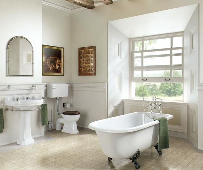 vitt badrum med bruna mönster, halvoval spegel, handfat i piedestal, klinkergolv, fönsteralkov