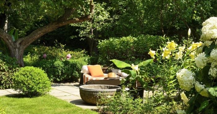 fotografia záhradnej terasy a záhrady, príklad toho, ako vyzdobiť dvorček lavičkou a ozdobnými vankúšmi