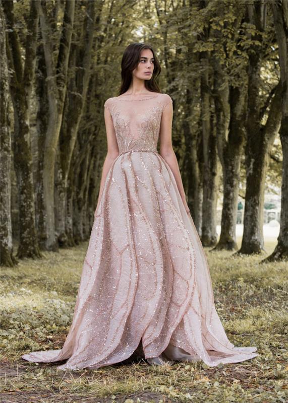 فستان العروس كوتور وردي فاتح مع ترتر وصدّار شفاف ، وتنورة مطوية ، وشعر طويل