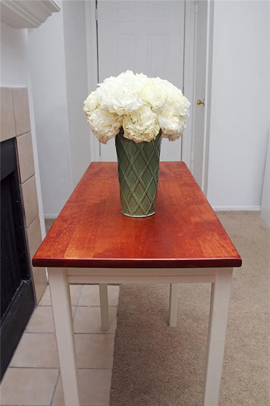 Stôl v kuchyni s vázou plnou bielych kvetov, akou farbou premaľovať drevenú skrinku, premena skrinky