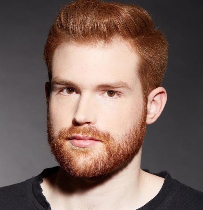 har ett vackert långt rött skägg med trendig frisyr för män