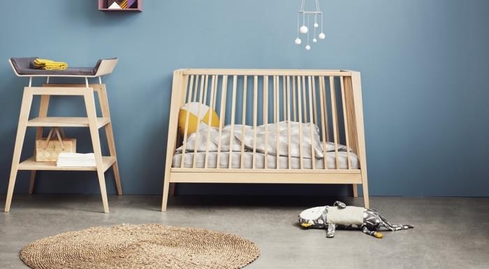 aký nábytok si vybrať pre výzdobu zmiešanej spálne s modrými stenami s detskou posteľou a prebaľovacím pultom zo svetlého dreva