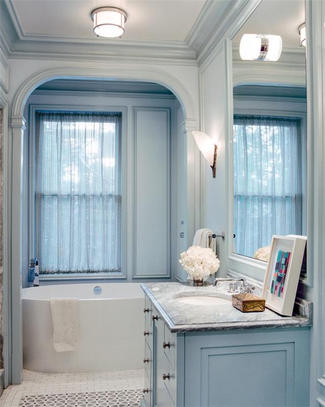 badrumsinredning i blått och vitt, idé att optimera det lilla utrymmet i ett badrum med litet badkar