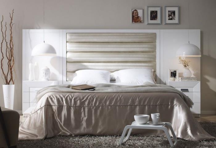 vuxen komplett sovrum med modern design med stor vit takbädd och inbyggda sängbord