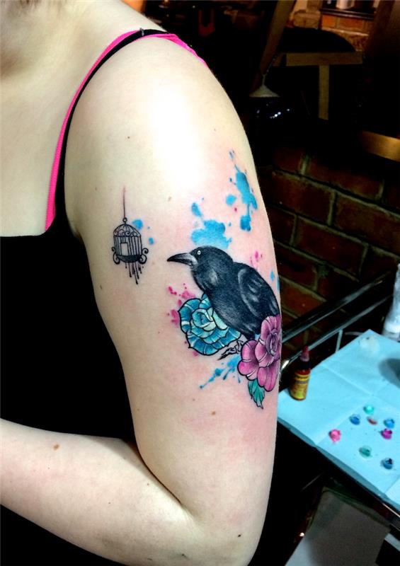 وشم ذراع امرأة الغراب الأسود مع زهور الفيروز والوردي والبقع المائية