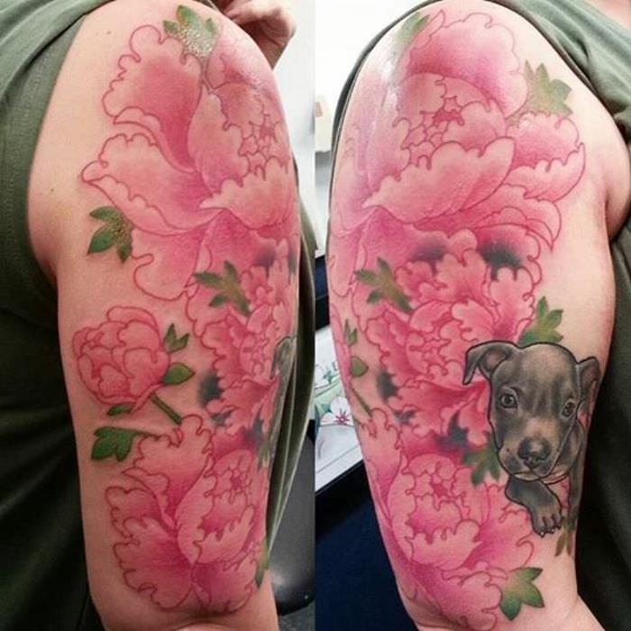 Kvitnúce ružové pivónie tetovanie, milý malý pes, potetovaná žena na ruke