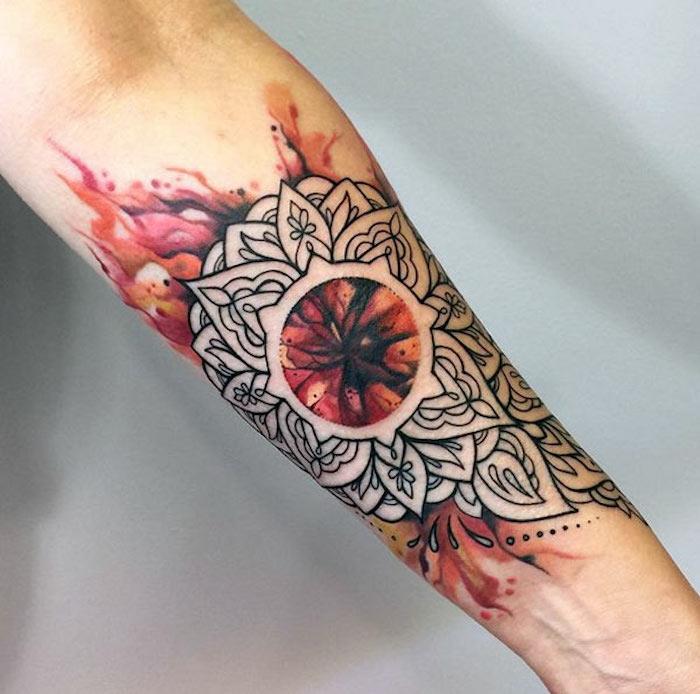 Tattoo avambraccio con motivi mandala e fiamme colorate