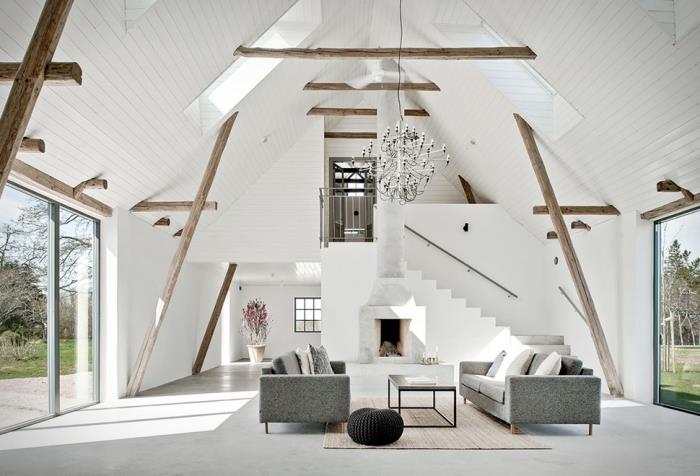 minimalistický štýl interiéru v modernom podkroví, nápad na usporiadanie stodoly s bielymi stenami a stropom s cementovou podlahou