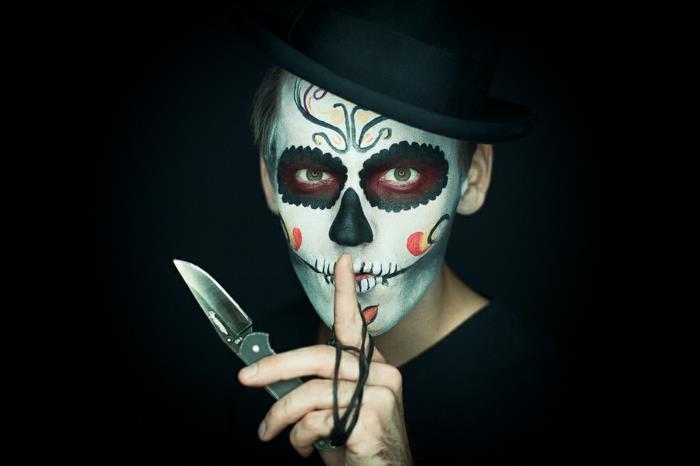 populär halloween -smink, mexikansk sockerskalle, en man som håller en kniv och skalle -smink